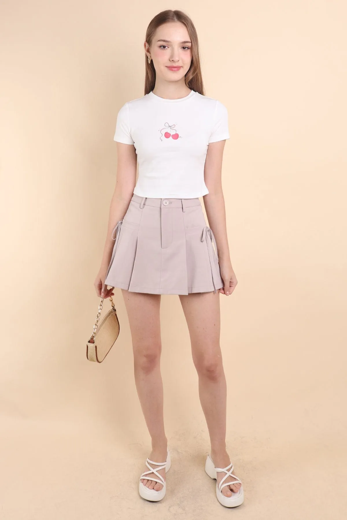 CLARE PLEATED TIE-KNOT SKORTS IN OAT ECRU